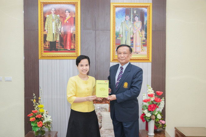 Tiến sỹ Trương Thị Hằng trao tượng trưng hơn 100 cuốn sách cho PGS. TS. Kittisak Samuttharak, Hiệu trưởng đại diện cho Đại học Rajabhat Lampang. (Ảnh: Hữu Kiên/TTXVN) Xuất bản sách tiếng Anh về Chủ tịch Hồ Chí Minh tại Thái Lan ảnh 1