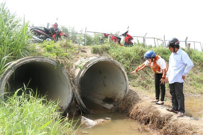 Những chất bẩn còn đọng lại của nước thải từ xe bồn xả xuống cống trên địa bàn xã Hướng Thọ Phú. (Ảnh: Trần Thanh Bình/TTXVN) Long An: Xe bồn bất ngờ xả chất thải xuống ven đường cao tốc ảnh 1