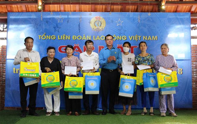 Ông Nguyễn Đình Khang, Chủ tịch Tổng liên đoàn Lao động Việt Nam trao quà và 5 triệu tiền mặt cho thân nhân các liệt sĩ đã hy sinh tại trận chiến đấu bảo vệ đảo Gạc Ma tại huyện Cam Lâm. (Ảnh: Phan Sáu/TTXVN) Khánh Hòa: Gặp mặt, tặng quà tri ân gia đình 64 liệt sỹ Gạc Ma ảnh 1