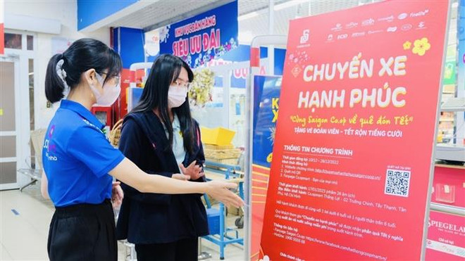 Sinh viên đăng ký về quê đón Tết bằng “Chuyến xe hạnh phúc - Cùng Saigon Co.op về quê ăn Tết”. (Ảnh: Thanh Vũ/TTXVN) Những chuyến xe Xuân nghĩa tình: 20 năm chuyên chở niềm vui ảnh 1