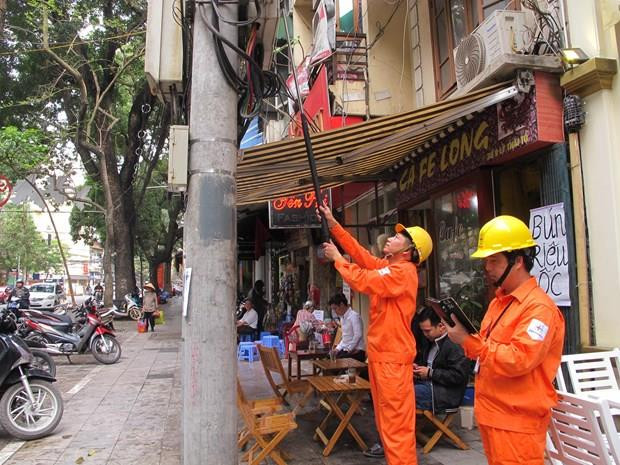 Nhân viên ngành điện đang chốt chỉ số công tơ của khách hàng. (Ảnh: Đức Duy/Vietnam+) Doanh nghiệp TP. HCM tìm cách thích ứng với giá điện tăng ảnh 1
