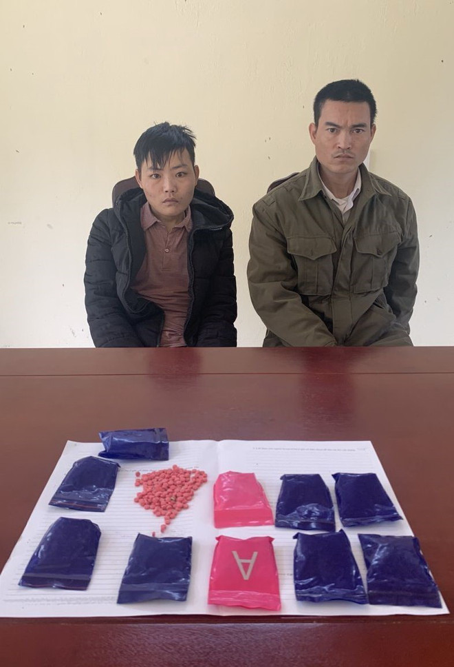Hai đối tượng Lương Văn Ước (trái) và Lò Khăm Thánh cùng tang vật vụ án tại cơ quan công an. (Ảnh: TTXVN phát) Bắt 2 đối tượng buôn ma túy, dùng dao chống trả lực lượng chức năng ảnh 1