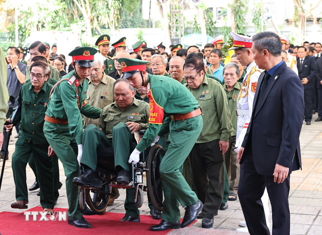 Lực lượng kiểm soát quân sự hỗ trợ, giúp đỡ các thương binh vào viếng Tổng Bí thư Nguyễn Phú Trọng. (Ảnh: TTXVN) TTXVN_2607vutrang6.jpeg.jpg