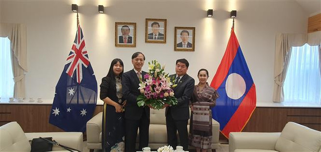 Đại sứ Nguyễn Tất Thành chúc mừng Đại sứ Sinchai Manivanh nhân dịp Tết cổ truyền Bun Pi May của Lào (Ảnh: TTXVN phát) Thúc đẩy quan hệ Việt-Lào nhân dịp Tết cổ truyền Bunpimay của Lào ảnh 1