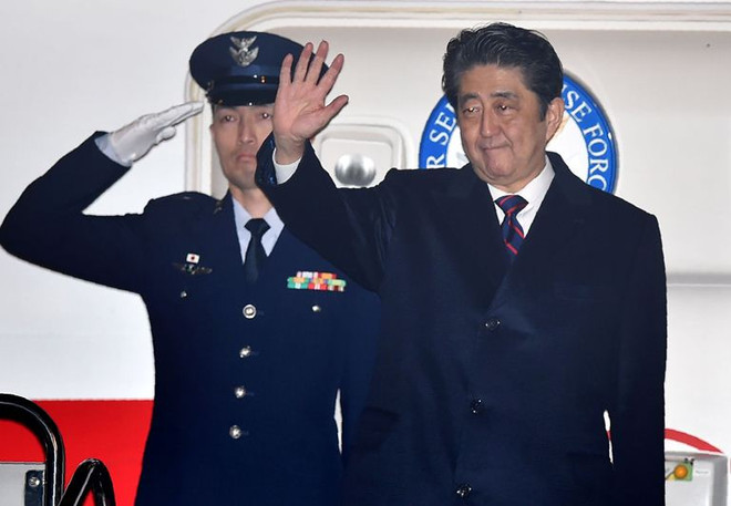 Thủ tướng Nhật Bản Shinzo Abe (phải) tại sân bay Haneda trước khi lên đường đến Hawaii ngày 26/12. (Nguồn: AFP/TTXVN) Thủ tướng Nhật Bản lên đường đến Hawaii thăm Trân Châu Cảng ảnh 1