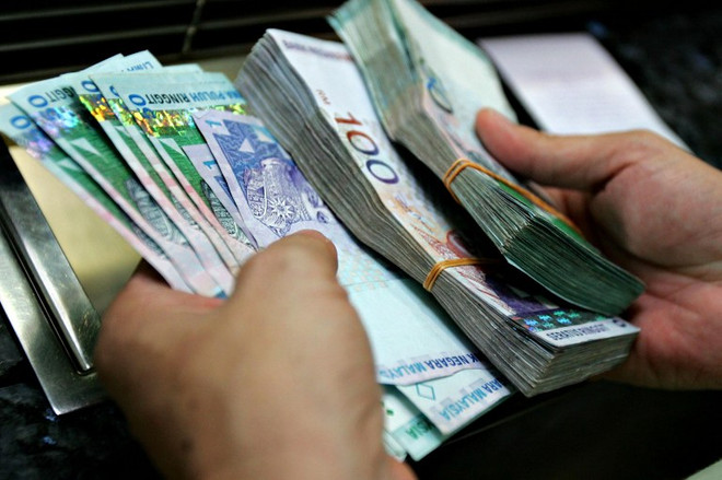 Đồng ringgit. (Nguồn: AFP) Dịch 2019-nCoV: Malaysia chuẩn bị công bố gói kích cầu kinh tế ảnh 1