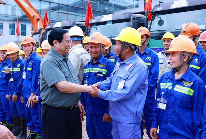 Thủ tướng Phạm Minh Chính với công nhân thi công dự án. (Ảnh: Dương Giang/TTXVN) ttxvn_nha ga t2 noi bai (5).jpg