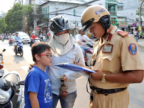 TP.HCM: Nhiều phụ huynh vẫn "lơ là" đội mũ bảo hiểm cho con ảnh 1
