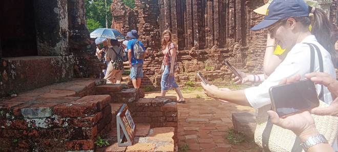 Đông đảo khách tham quan Di sản Văn hóa Thế giới Mỹ Sơn trải nghiệm với thuyết minh đa ngôn ngữ. (Ảnh: Đoàn Hữu Trung/TTXVN) Di sản Thế giới Mỹ Sơn: Khai trương sản phẩm thuyết minh đa ngôn ngữ ảnh 1