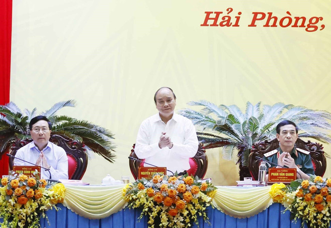 Chủ tịch nước Nguyễn Xuân Phúc chủ trì hội thảo. (Ảnh: Thống Nhất/TTXVN) Hội thảo lý luận-thực tiễn về bảo vệ Tổ quốc trong tình hình mới ảnh 1