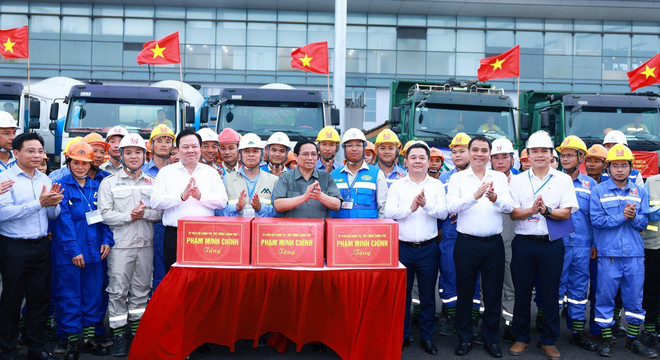 Thủ tướng Phạm Minh Chính tặng quà động viên kỹ sư, công nhân thi công dự án. (Ảnh: Dương Giang/TTXVN) ttxvm_khoi cong T2 2 (1).jpg