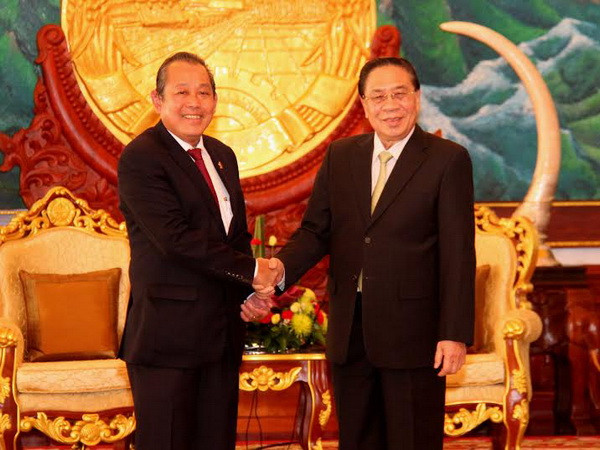 Chủ tịch nước Lào Chummaly Saynhasone tiếp ông Trương Hòa Bình, Bí thư Trung ương Đảng, Chánh án Tòa án Nhân dân Tối cao. (Ảnh: Hoàng Chương/Vietnam+) Lào đánh giá cao sự giúp đỡ của Tòa án Nhân dân Tối cao Việt Nam ảnh 1