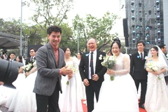 Nghệ sỹ Nhân dân Xuân Bắc - Cục trưởng Cục Nghệ thuật Biểu diễn trở thành MC và "chủ hôn" cho 80 cặp đôi đủ các độ tuổi, từ các cặp chưa thành hôn đến những cặp "đám cưới kim cương" 50 năm. (Ảnh: Minh Anh/Vietnam+)
