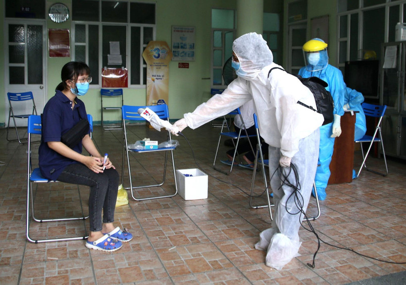 Phóng viên kênh truyền hình Thông tấn VNews tác nghiệp tại khu vực có nguy cơ lây nhiễm. (Ảnh: Quốc Dũng/TTXVN) 