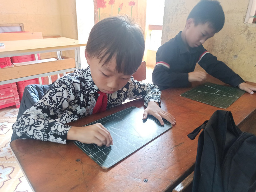 Lý A Mạnh (bên trái), học sinh lớp 4A1, Trường Tiểu học Khao Mang, Mù Cang Chải, Yên Bái trong giờ học tiếng Anh trực tuyến. (Ảnh: PV/Vietnam+)