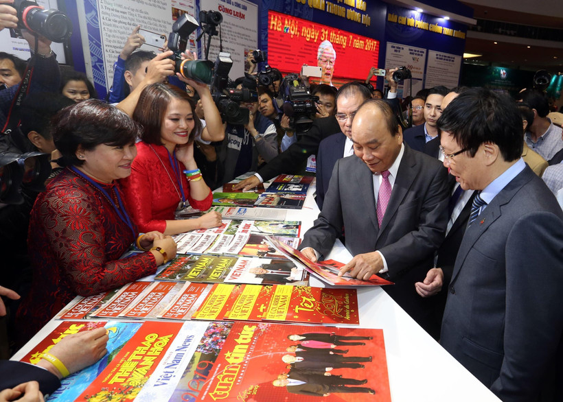 Thủ tướng Nguyễn Xuân Phúc thăm gian trưng bày của Thông tấn xã Việt Nam tại Hội báo toàn quốc 2019. (Ảnh: Huy Hùng/TTXVN)