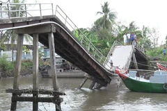 Hiện trường chiếc ghe chở lúa đâm sập cầu Phong Hòa, huyện Lai Vung, Đồng Tháp. (Ảnh: TTXVN phát)
