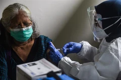 Nhân viên y tế tiêm vắcxin phòng COVID-19 cho người dân tại Jakarta, Indonesia, ngày 24/2/2021. (Ảnh: THX/TTXVN)