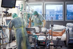 Nhân viên y tế điều trị cho bệnh nhân nhiễm COVID-19. (Ảnh: AFP/TTXVN)