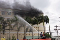 Lực lượng Cảnh sát PCCC Cần Thơ nỗ lực phun nước để dập lửa. (Ảnh: Thanh Liêm/TTXVN)