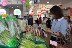 Người dân đi mua sắm tại siêu thị Saigon Co.opmart. (Ảnh: Thanh Vũ/TTXVN)