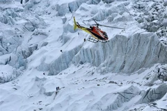 Trực thăng bay trên núi thuộc khu vực Everest (Nepal). (Ảnh: AFP/TTXVN)
