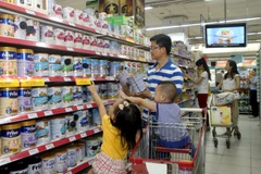 Người tiêu dùng chọn mua sản phẩm sữa giảm giá tại hệ thống bán lẻ của Saigon Co.op. (Ảnh: Thanh Vũ/TTXVN)