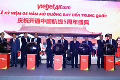 Thủ tướng Nguyễn Xuân Phúc và các đại biểu thực hiện nghi thức kỷ niệm 05 năm Vietjet Air mở đường bay tới Trung Quốc. (Ảnh: Thống Nhất/TTXVN)