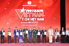 Trung tướng Nguyễn Văn Gấu - Ủy viên Trung ương Đảng, Phó chủ nhiệm Tổng cục Chính trị Quân đội Nhân dân Việt Nam trao biểu trưng vinh danh Vinh quang Việt Nam cho các cá nhân. (Ảnh: Minh Đức/TTXVN)