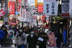 Người dân đeo khẩu trang phòng dịch COVID-19 khi đi trên đường phố tại Osaka (Nhật Bản). (Ảnh: Kyodo/TTXVN)