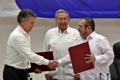 Tổng thống Colombia Juan Manuel Santos (trái), thủ lĩnh FARC Timoleon Jimenez (phải) và Chủ tịch Cuba Raul Castro tại lễ ký kết ở La Habana (Cuba), ngày 23/6. (Nguồn: EPA/TTXVN)