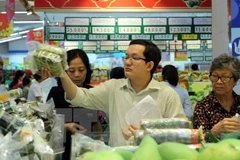 Người tiêu dùng chọn lựa rau củ quả tại siêu thị. (Ảnh: Thanh Vũ/TTXVN)