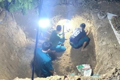 Triển khai quy tập hài cốt liệt sỹ tại khu vực hộ dân đào móng làm nhà ở tổ 7, khu phố Kiến An, phường An Điền, thành phố Bến Cát, tỉnh Bình Dương. (Ảnh: TTXVN phát)