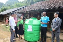 Đại diện UNICEF trao bồn chứa nước cho các xã nghèo của tỉnh Cao Bằng. (Ảnh: Chu Hiệu/TTXVN)
