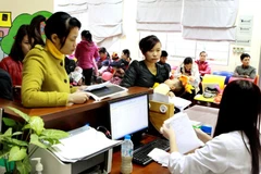 Làm thủ tục khám bệnh tại Bệnh viện Nhi Trung ương. (Ảnh: TTXVN/Vietnam+)