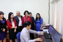 Tổng Giám đốc Bảo hiểm Xã hội Việt Nam Nguyễn Thị Minh kiểm tra hoạt động của hệ thống một cửa điện tử tập trung. (Ảnh: PV/Vietnam+)