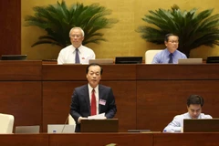 Bộ trưởng Bộ Xây dựng Phạm Hồng Hà trả lời chất vấn của đại biểu Quốc hội. (Ảnh: Phương Hoa/TTXVN)