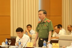 Bộ trưởng Bộ Công an Tô Lâm trả lời chất vấn của các đại biểu Quốc hội. (Ảnh: Dương Giang/TTXVN)
