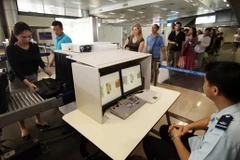 Sử dụng hệ thống máy soi kiểm tra hành lý khách nhập cảnh qua cửa khẩu Quốc tế sân bay Nội Bài. (Ảnh: Phạm Hậu/TTXVN)