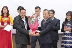 Đại sứ Việt Nam tại Nhật Bản Vũ Hồng Nam tặng hoa cho Chủ tịch Hội người Việt Nam tại tỉnh Aichi. (Ảnh: Thành Hữu/TTXVN)