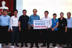 Bộ Giáo dục và Đào tạo trao tặng sách giáo khoa cho học sinh vùng lũ. (Ảnh: Tường Vi/TTXVN)