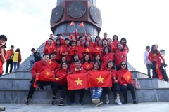 Du khách chụp ảnh tại Cột cờ Lũng Cú, điểm cực Bắc của Tổ quốc. (Ảnh: Vietnam+)