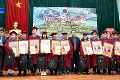 Trao chứng chỉ hành nghề và tặng quà của Bộ trưởng Bộ Y tế cho các bác sỹ tốt nghiệp. (Ảnh: PV/TTXVN)