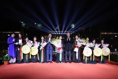 Chủ tịch Quốc hội Vương Đình Huệ tặng hoa chúc mừng các nghệ nhân quan họ và thiếu nhi tham gia biểu diễn dân ca quan họ Bắc Ninh. (Ảnh: Thanh Thương/TTXVN)