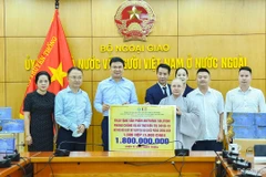 Thứ trưởng Ngoại giao Phạm Quang Hiệu, Chủ nhiệm Ủy ban Nhà nước về người Việt Nam ở nước ngoài tiếp nhận sản phẩm hỗ trợ điều trị COVID-19. (Nguồn: Báo Quốc tế)