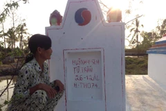 Chị Lê Thị Lụm vẫn khắc khoải chờ 2 chữ 'công lý' sẽ đến với gia đình mình. (Ảnh: PV/Vietnam+)