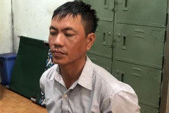 Đối tượng Trương Tấn Đạt tại cơ quan công an vào trưa 20/10. (Ảnh: Thế Anh/TTXVN) 