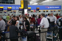 Hành khách chờ làm thủ tục tại sân bay Heathrow ở London. (Ảnh: AFP/TTXVN)