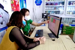 Nhân viên Tiki hướng dẫn các tiểu thương. (Ảnh: CTV/Vietnam+)