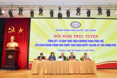 Phó Thường trực Trương Hòa Bình cùng ban lãnh đạo Ngân hàng Nhà nước chỉ đạo tại Hội nghị. (Ảnh: CTV/Vietnanm+)
